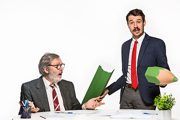 Image showing The two colleagues working together at office on white background.