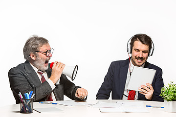 Image showing The two colleagues working together at office on white background.