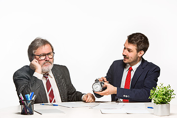 Image showing The two colleagues working together at office on white background.