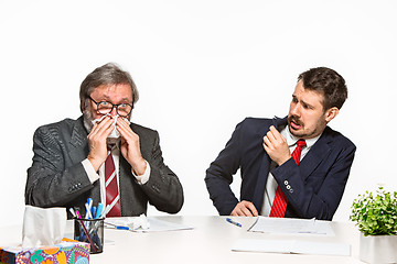 Image showing The two colleagues working together at office on white background.