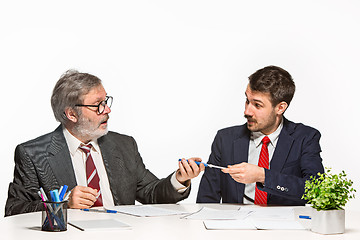 Image showing The two colleagues working together at office on white background.