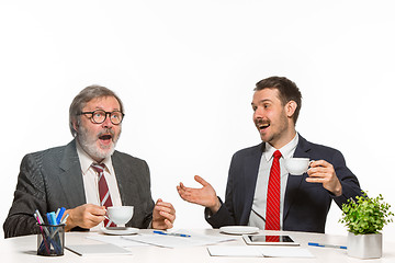 Image showing The two colleagues working together at office on white background.