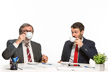 Image showing The two colleagues working together at office on white background.