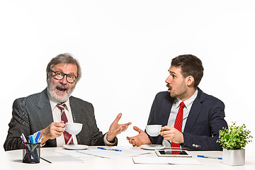 Image showing The two colleagues working together at office on white background.