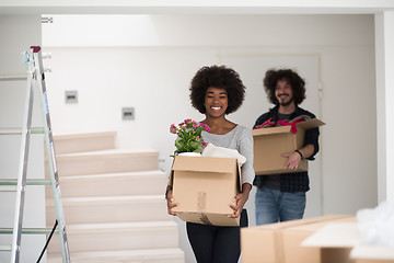 Image showing multiethnic couple moving into a new home