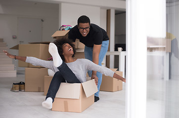 Image showing African American couple  playing with packing material