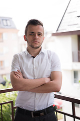 Image showing man standing at balcony