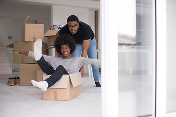 Image showing African American couple  playing with packing material