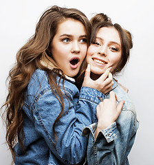 Image showing lifestyle people concept: two pretty stylish modern hipster teen girl having fun together, happy smiling making selfie