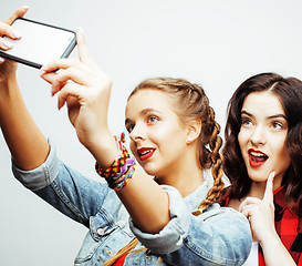 Image showing lifestyle people concept: two pretty stylish modern hipster teen girl having fun together, happy smiling making selfie