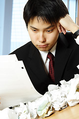Image showing Stressed asian businessman