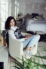 Image showing young pretty woman in her bedroom sitting in chair, lifestyle people concept