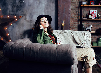 Image showing young pretty woman waiting alone in modern loft studio, fashion musician concept, lifestyle people