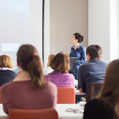 Image showing Woman giving presentation in lecture hall at university.