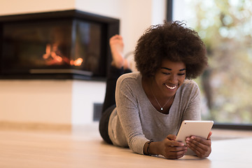 Image showing black women used tablet computer on the floor