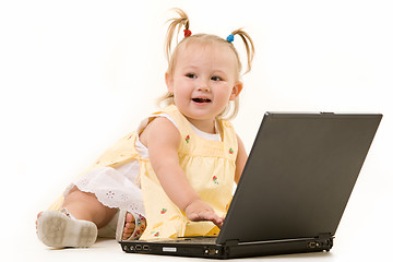 Image showing Adorable baby with laptop