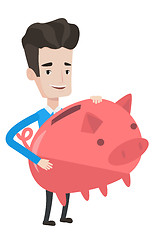 Image showing Businessman holding a big piggy bank.