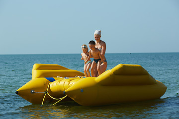 Image showing two children with mom on the dinghy sailing at sea in summer