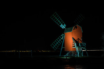 Image showing Illuminated old wooden windmill