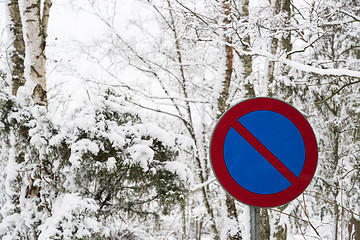 Image showing No parking roadsign surrounded of snow