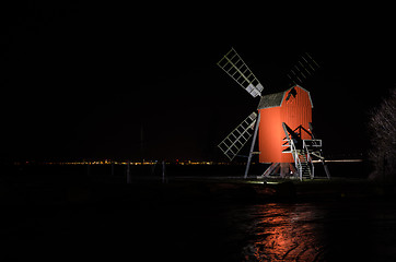 Image showing Red old traditional windmill by night