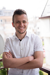 Image showing man standing at balcony