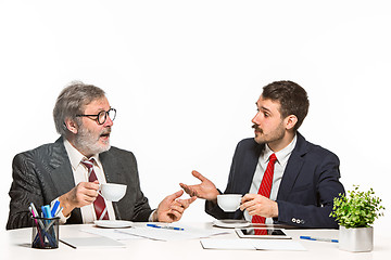 Image showing The two colleagues working together at office on white background.