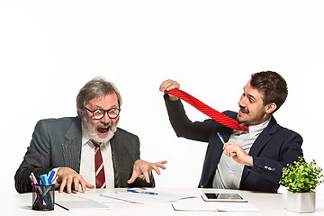 Image showing The two colleagues working together at office on white background.