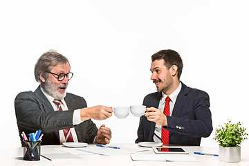 Image showing The two colleagues working together at office on white background.