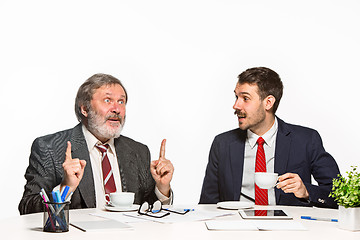 Image showing The two colleagues working together at office on white background.