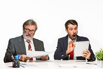 Image showing The two colleagues working together at office on white background.