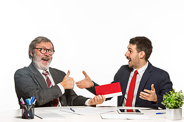 Image showing Concept - corruption. Businessman in a suit taking a bribe