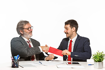 Image showing Concept - corruption. Businessman in a suit taking a bribe