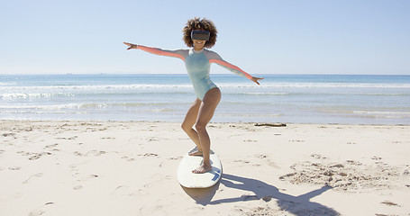 Image showing Female wearing virtual reality glasses on beach