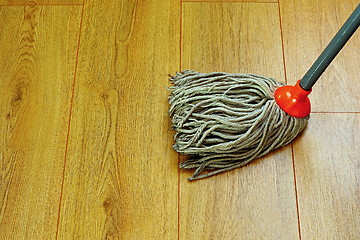 Image showing washing wood floor with wet mop