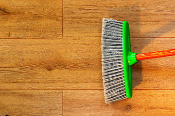 Image showing cleaning wooden floor with broom