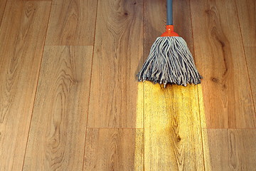 Image showing cleaning wooden floor with a mop