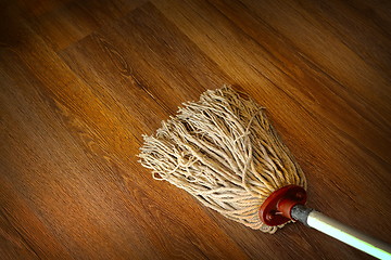 Image showing washing the wood floor with an old mop