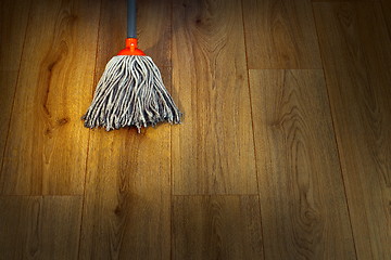 Image showing wet mop on wooden floor