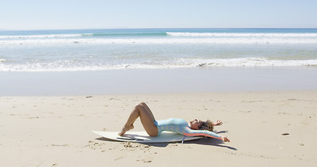 Image showing Young woman on a surfboard