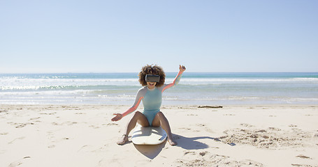 Image showing Female on beach wearing virtual reality glasses