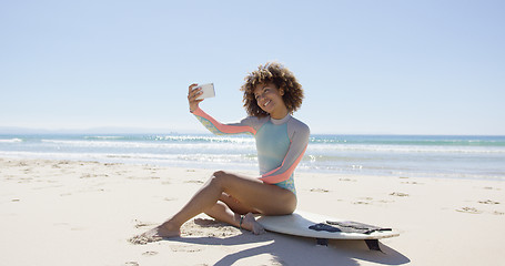 Image showing Female taking selfie on beach