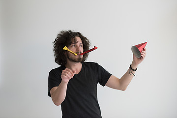 Image showing Portrait of a man in party hat blowing in whistle