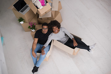 Image showing African American couple  playing with packing material