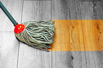 Image showing washing wooden floor with wet mop