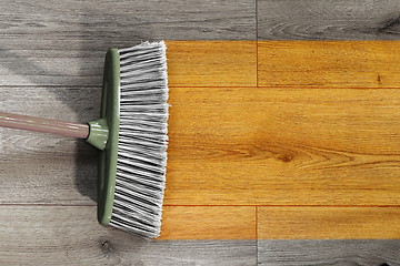 Image showing sweeping wooden floor with broom