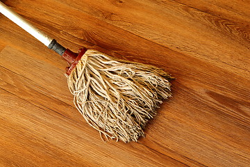 Image showing old mop on wooden parquet