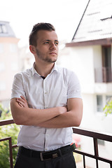 Image showing man standing at balcony