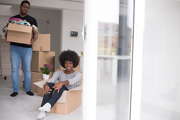 Image showing African American couple  playing with packing material