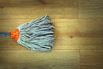 Image showing closeup of mop head cleaning on wooden parquet